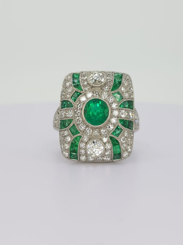Art Deco Style Emerald and Diamond Cluster Dress Ring; round faceted emerald surrounded by 1.56cts brilliant diamonds and calibre emeralds, in 18ct white gold