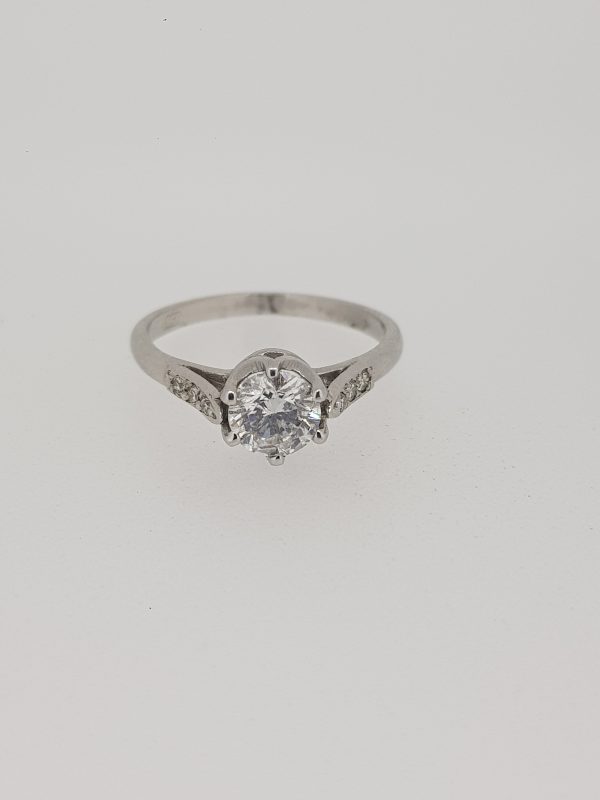0.96ct Diamond Solitaire Engagement Ring with Diamond Shoulders; central six claw-set 0.96 carat round brilliant-cut diamond flanked by diamond set shoulders, in 18ct white gold