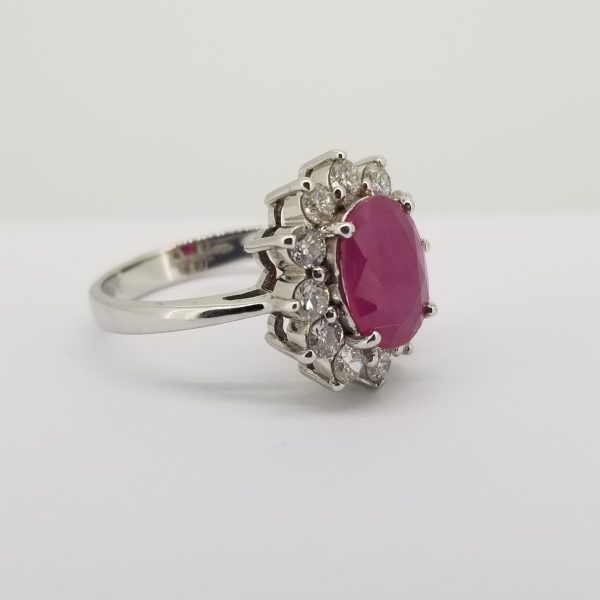 Ruby and Diamond Oval Cluster Ring; central 3ct oval faceted ruby set within a 1ct diamond surround, in 18ct white gold