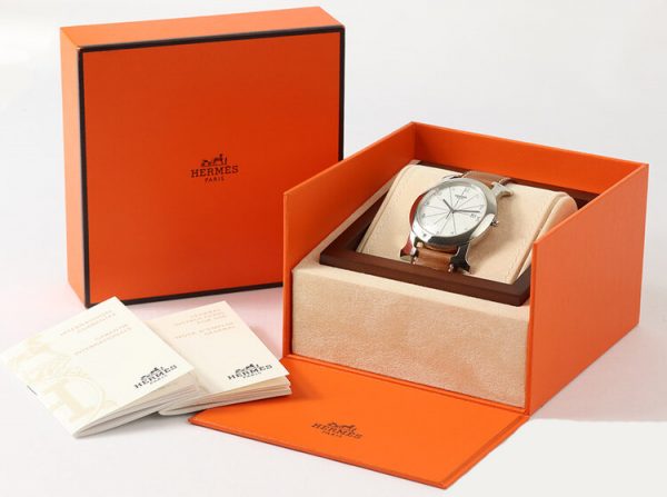 Hermes Heure H Ronde HR1.710 Steel 40mm Quartz Watch; white dial with Arabic numerals, date indicator and sapphire crystal, on a brown leather strap, with Hermes box and papers