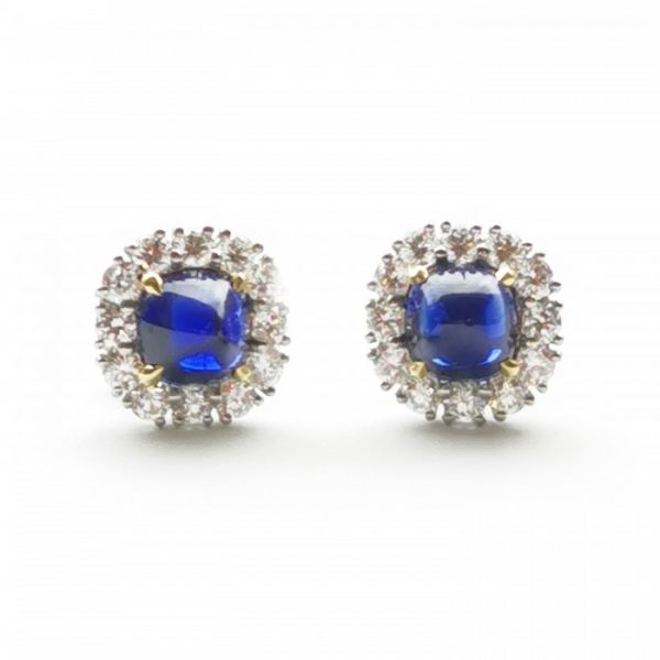 Sapphire and Diamond Cluster Stud Earrings; 2.83cts cabochon-cut "sugar-loaf" sapphires surrounded by 1.02cts round brilliant-cut diamonds, claw set and mounted in platinum, with certificate stating the sapphires are natural and unheated