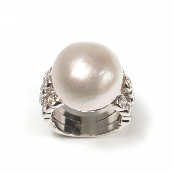 Vintage Baroque Mabe Pearl and Diamond Cocktail Ring; 16mm mabé pearl with shoulders set with three rows of graduating round brilliant-cut diamonds, 1.50 carat total, in 18ct white gold, Circa 1990