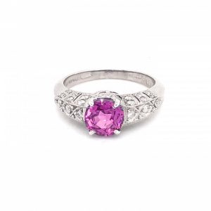 Pink Sapphire and Diamond Ring in Platinum; central 1.57ct pink sapphire accented with 0.31cts round brilliant-cut diamonds set in the decorative pierced shoulders, head and bezel, with millegrain edges
