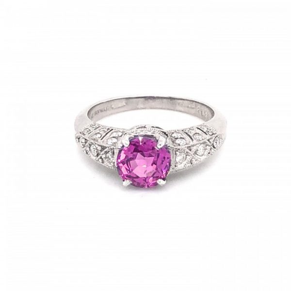 Pink Sapphire and Diamond Ring in Platinum; central 1.57ct pink sapphire accented with 0.31cts round brilliant-cut diamonds set in the decorative pierced shoulders, head and bezel, with millegrain edges