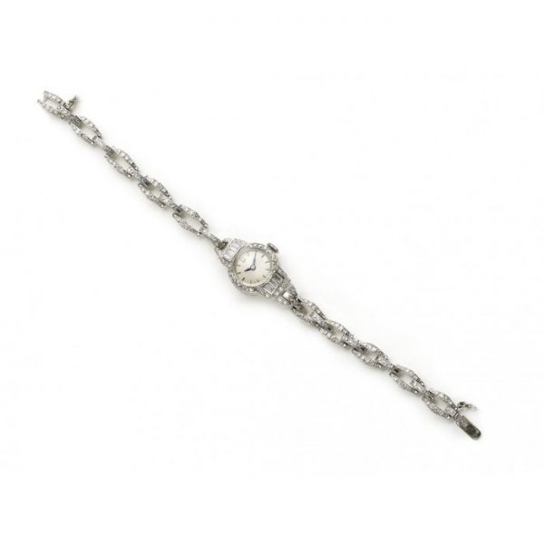 Art Deco Diamond and Platinum Cocktail Watch, set with eight-cut diamonds in the bezel and bracelet, and baguette cut diamond lugs, manual wind movement signed Bueche-Girod