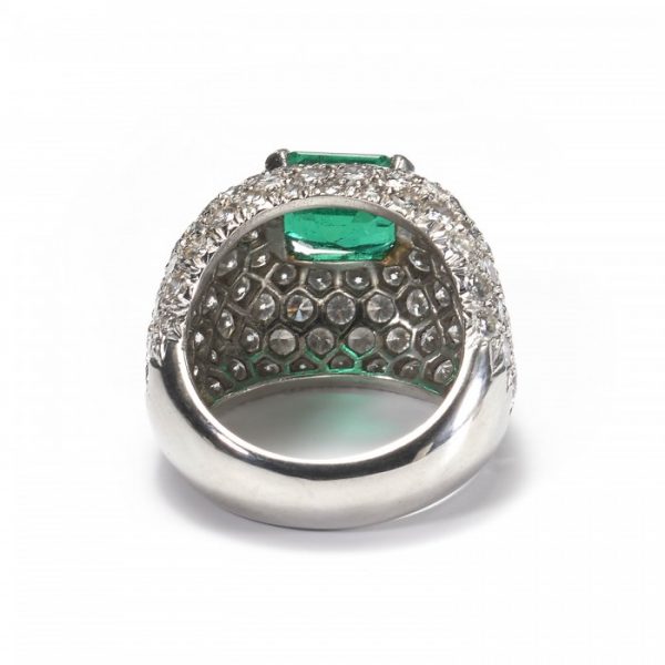 Emerald and Diamond Bombe Cluster Ring, central 2.40ct emerald-cut emerald surrounded by 6cts of brilliant-cut diamonds in a pavé setting, in 18ct white gold