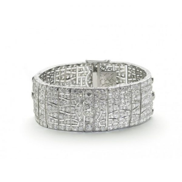 Art Deco Diamond Bracelet in Platinum, set with 23 carats of old-cut and eight-cut diamonds, panel links with wavy detailed design, Circa 1930