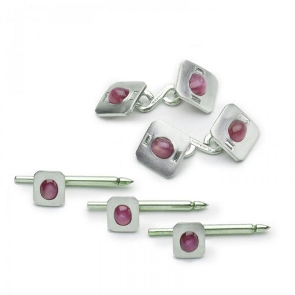 Vintage Tiffany and Co Star Ruby and Platinum Dress Set; comprising a pair of cufflinks and three dress studs, each set with an oval cabochon star ruby with cut corners, cufflinks accented with diamonds, Signed, Circa 1950