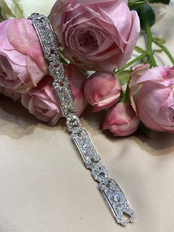 Art Deco Diamond Bracelet in Platinum; alternating platinum panels and links set with 12 carats of diamonds
