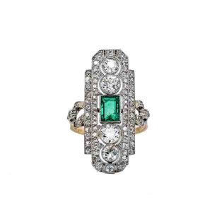 Art Deco Emerald and Diamond Panel Ring; central emerald-cut emerald accented with 3.50 carat brilliant-cut diamond-set pierced surround, in platinum and 18ct yellow gold
