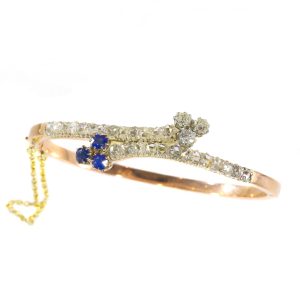 Antique Victorian Sapphire and Diamond Crossover Bangle Bracelet; set with 0.75cts blue sapphires and 0.60cts old mine-cut diamonds, accented with rose-cut diamonds, in silver and 18ct rose gold, Circa 1880
