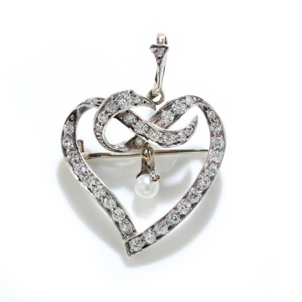 Art Deco Old Cut Diamond Heart Brooch with Natural Pearl; openwork heart brooch set with 1.85 carats old-cut diamonds and central suspended natural pearl, in silver and 18ct gold, Circa 1920s