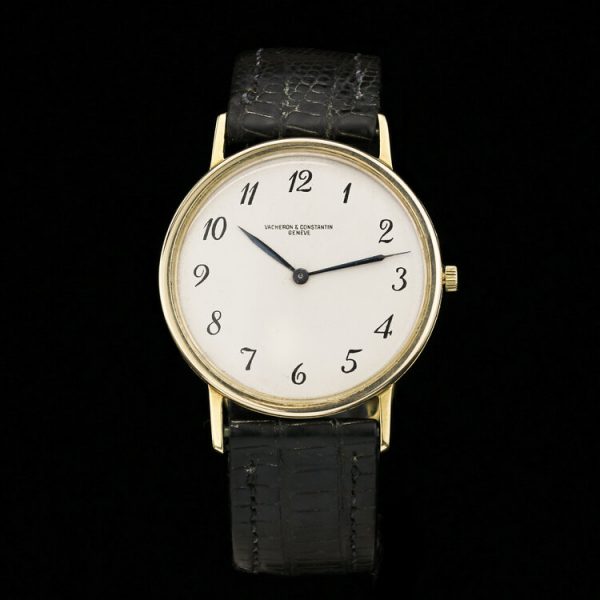 Vintage Vacheron Constantin 18ct Yellow Gold 33mm Manual Watch, white dial with black Arabic numerals, on a black leather strap. Circa 1960s