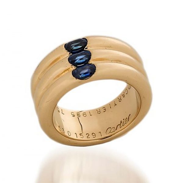 Cartier 18ct Gold Triple Ring Band with Sapphires; 18ct yellow gold triple ring band set with three oval facetted blue sapphires totalling 0.45cts, in original box. Made in France, Paris 1995. Fully hallmarked, signed Cartier and numbered