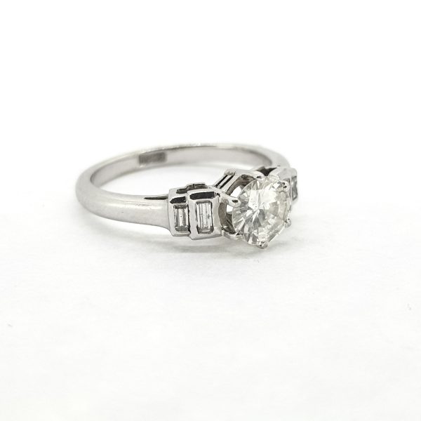 0.70ct Diamond Solitaire Ring with Baguette Shoulders; central 0.70ct brilliant-cut diamond flanked by 0.30cts stepped baguette-cut diamond shoulders, in 18ct white gold