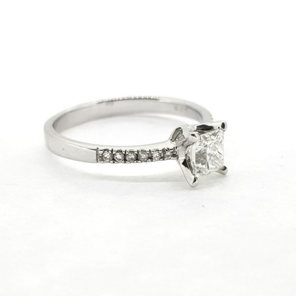Princess Cut Diamond Engagement Ring; central claw-set 0.63ct princess-cut diamond accented with delicate diamond set shoulders, in 18ct white gold
