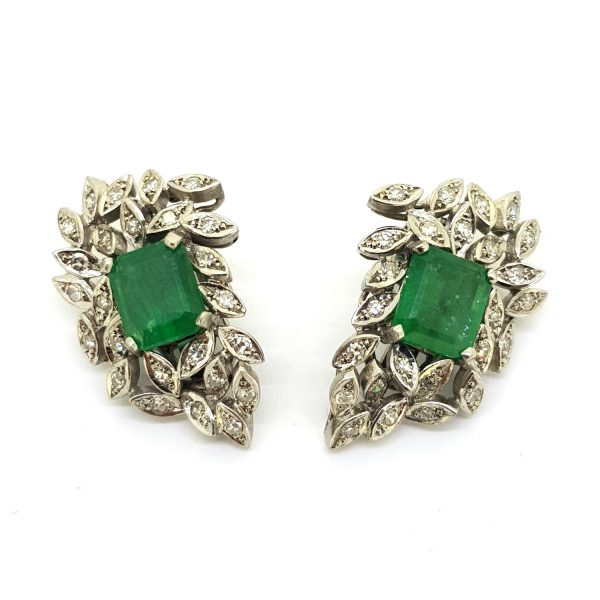 Vintage Emerald and Diamond Cluster Clip On Earrings; central emerald-cut emerald within a diamond leaf spray design surround in 18ct white gold