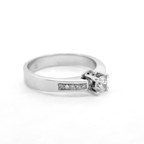 Single Stone Diamond Engagement Ring; central claw-set 0.39ct round brilliant-cut diamond accented with diamond set shoulders, in 18ct white gold