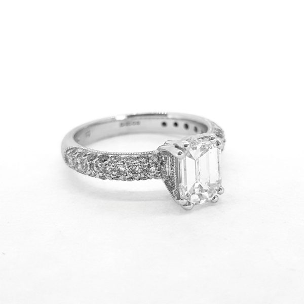 Emerald Cut Diamond Engagement Ring; featuring a claw set 1ct emerald-cut diamond accented with pave-set diamond shoulders, in 18ct white gold