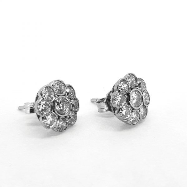Diamond Flower Cluster Earrings, 1.50 carat total, each featuring a central round cut diamond surrounded by eight further diamonds, in 18ct white gold