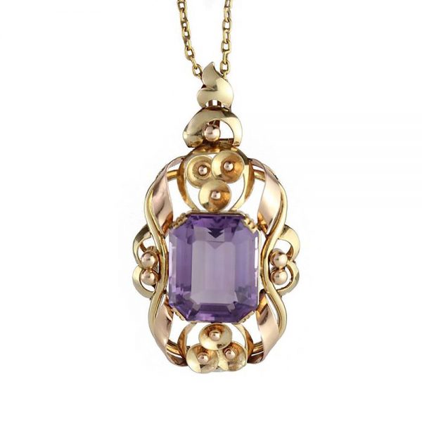 Vintage Amethyst and Gold Pendant; featuring a central 14 carat emerald-cut amethyst nestled within a 14ct yellow gold scrolled design. Chain is not included