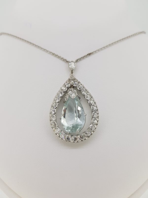 Aquamarine and Diamond Drop Pendant Necklace; pear-shaped aquamarine suspended within an open diamond-set halo, in 18ct white gold
