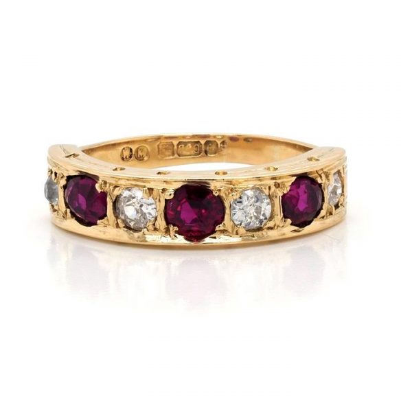 Vintage Ruby and Diamond Seven Stone Ring in 18ct Yellow Gold; set with three round faceted rubies and four old cut diamonds totalling 0.50cts
