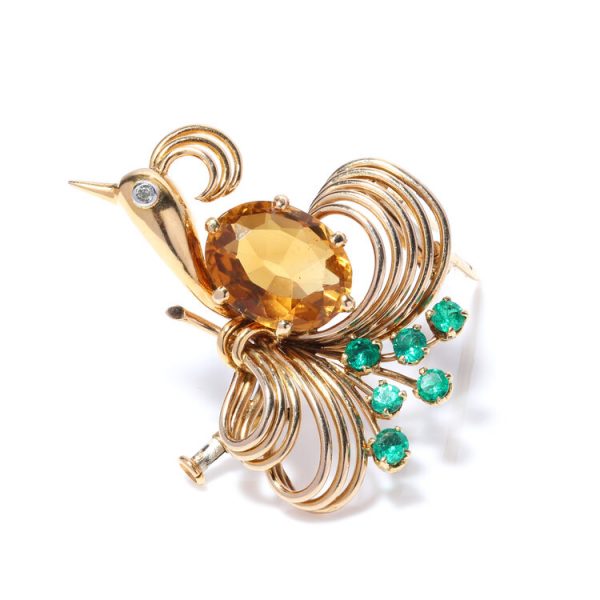 Art Deco French Peacock Brooch with 4ct Citrine, Diamond and Emeralds; 18ct yellow gold brooch in the form of a peacock; set with a large 4ct oval citrine to the body, a rose-cut diamond-set eye and six emeralds accent the tail feathers. Made in France, Circa 1920s