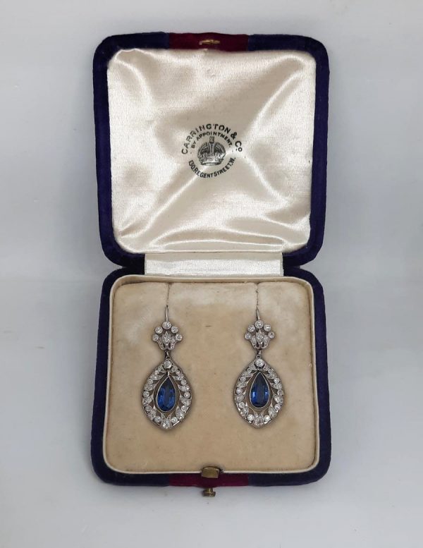 Belle Epoque Sapphire and Diamond Drop Earrings; 2.50cts pear-shaped sapphires with old-cut diamond surround and floral tops, in openwork platinum with millegrain edging