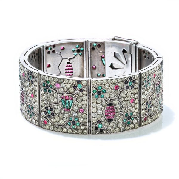 Art Deco Silver Bracelet with Rubies, Emeralds, Sapphires and Paste; silver panel bracelet set with an intricate design of paste, 2cts rubies, 2cts emeralds and 1.80cts blue sapphires