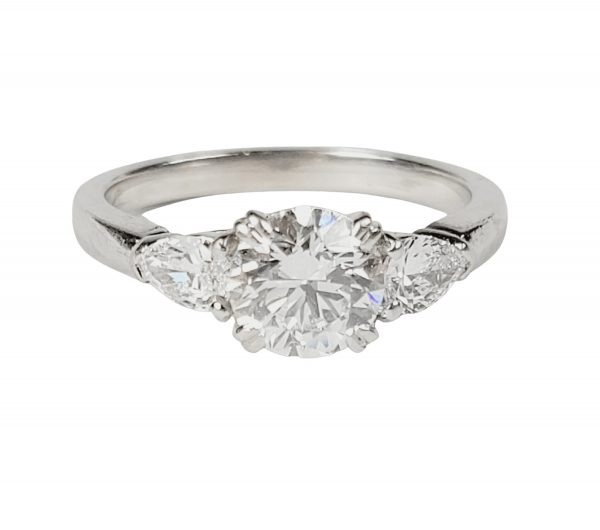 0.91ct D Colour Diamond Engagement Ring in Platinum; central claw-set 0.91ct D SI1 round brilliant-cut diamond flanked by pear-cut diamonds, by Hancocks