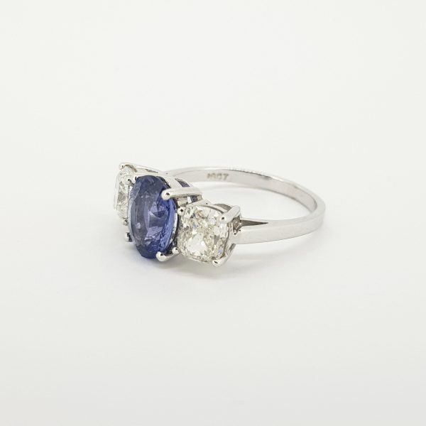 Natural Sapphire and Diamond Three Stone Ring; central 2.52 carat natural oval blue sapphire flanked by 2cts cushion-shaped diamonds, in 18ct white gold