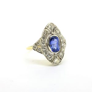 Art Deco Style Sapphire and Diamond Dress Ring; central 1.75ct oval sapphire set within 0.95ct diamond-set pierced surround, in platinum and 18ct yellow gold, Circa 1980
