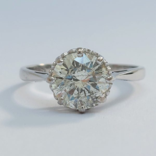 A vintage single stone diamond 18ct white gold ring, the round brilliant cut diamond know to weigh 1.71ct is eight claw set to a tapering white gold band.