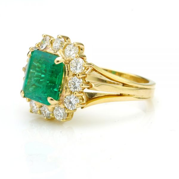 3.80ct Emerald Cut Emerald and Diamond Cluster Ring, in 18ct yellow gold with triple-split shoulders