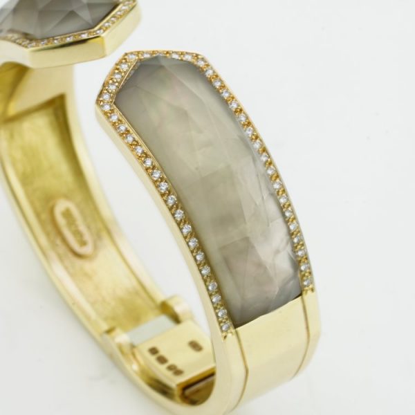 Stephen Webster Bangle Bracelet from Crystal Haze Collection; two faceted quartz crystal sections overlay a layer of Mother of Pearl, surrounded by 0.90cts brilliant cut diamonds, in 18ct yellow gold