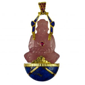 French Rose Quartz Buddha Pendant with Lapis Lazuli and Rubies; 150ct carved rose quartz Buddha sitting in prayer on a cabochon of lapis lazuli, set with rubies to the pendant bail and chest, 18ct yellow gold settings