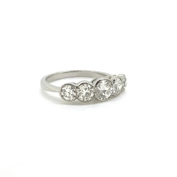 Five Stone Old Cut Diamond Ring in Platinum, set with 1.50 carats of graduated old-cut diamonds in a rub over setting