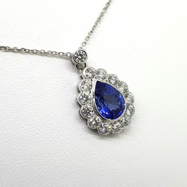 2.10ct Pear Cut Sapphire and Diamond Cluster Pendant with Chain; 2.10ct pear cut sapphire within a 0.80ct diamond surround, in 18ct white gold