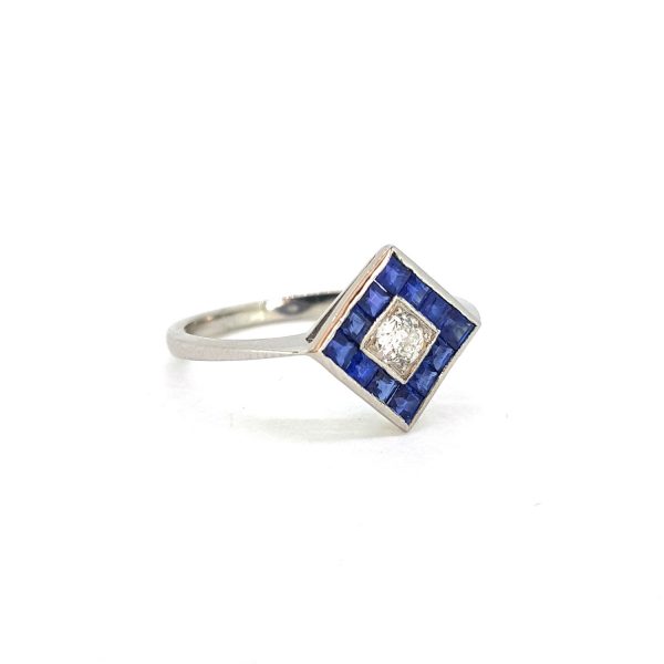 Contemporary Sapphire and Old Cut Diamond Cluster Ring; central old cut diamond set within a calibre sapphire surround in a diamond-shaped mount in platinum