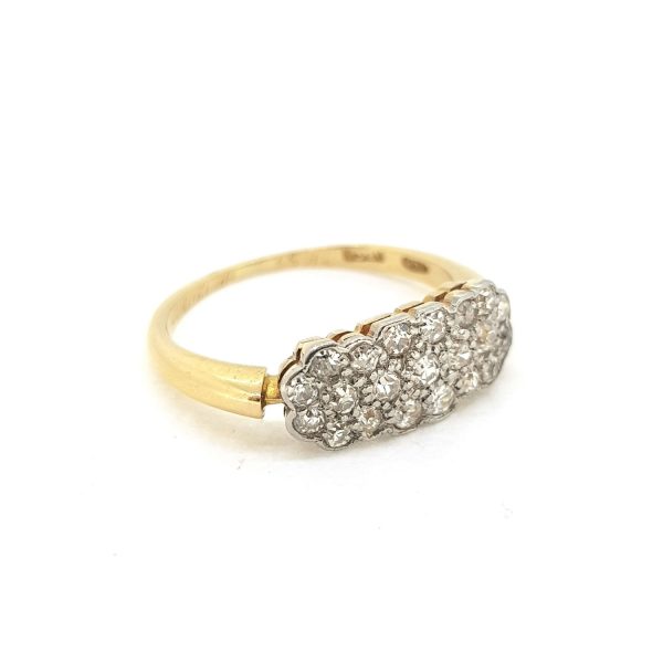 Diamond Cluster Ring; featuring multiple interconnecting diamond clusters collet set and mounted to an 18ct yellow gold band