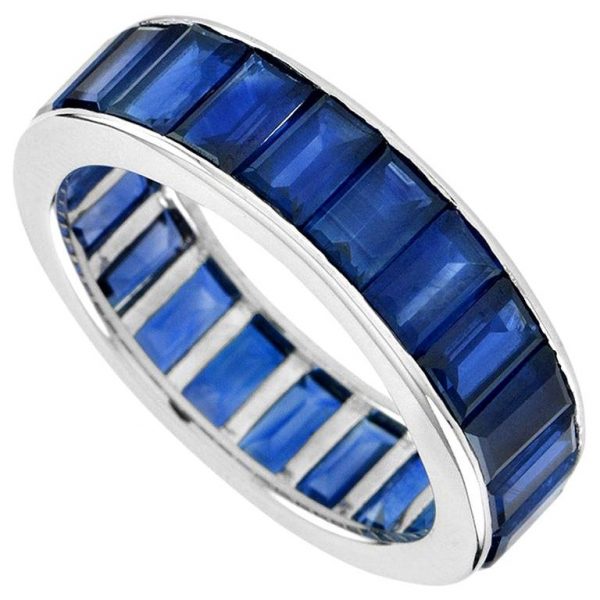 Baguette Sapphire Full Eternity Ring in 18ct Gold; set with twenty-two vertically channel-set baguette-cut sapphires totalling 14.3 carats. Made to order