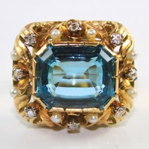Vintage 1940s Retro 16ct Aquamarine Ring with Diamonds and Pearls; central 16 carat emerald-cut aquamarine nestled in a sculptured yellow gold mount accented with round brilliant-cut diamonds and pearls