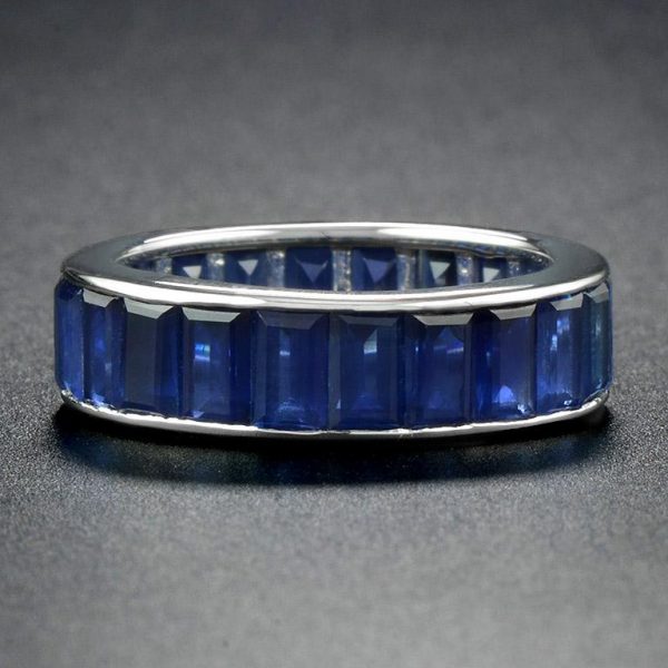 Baguette Sapphire Full Eternity Ring in 18ct Gold; set with twenty-two vertically channel-set baguette-cut sapphires totalling 14.3 carats. Made to order