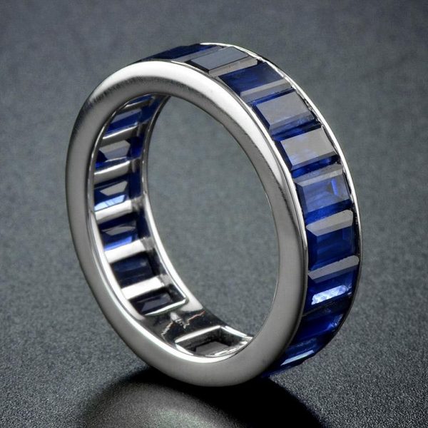 Baguette Sapphire Full Eternity Ring in 18ct Gold; set with twenty-two vertically channel-set baguette-cut sapphires totalling 14.3 carats. Made to order