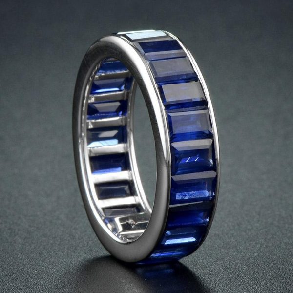 Baguette Sapphire Full Eternity Ring in 18ct Gold; set with twenty-two vertically channel-set baguette-cut sapphires totalling 14.3 carats. Made to order