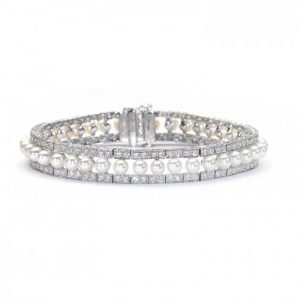 Modern Pearl and Diamond Bracelet in Platinum, row of forty-one cultured pearls flanked either side by 3.81cts round brilliant-cut diamonds in paired grain settings