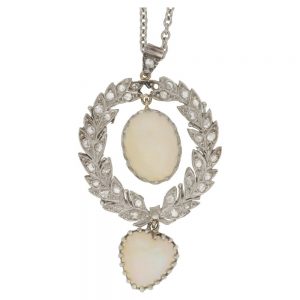 Antique Belle Epoque Opal and Diamond Wreath Pendant; oval cabochon white opal within rose-cut diamond-set platinum wreath suspending a heart-shape cabochon white opal, in platinum and gold