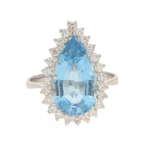 4.85ct Pear Cut Aquamarine and Diamond Cluster Cocktail Ring; 4.85 carat pear mixed-cut aquamarine surrounded by a halo of 0.48cts round brilliant-cut diamonds in white gold
