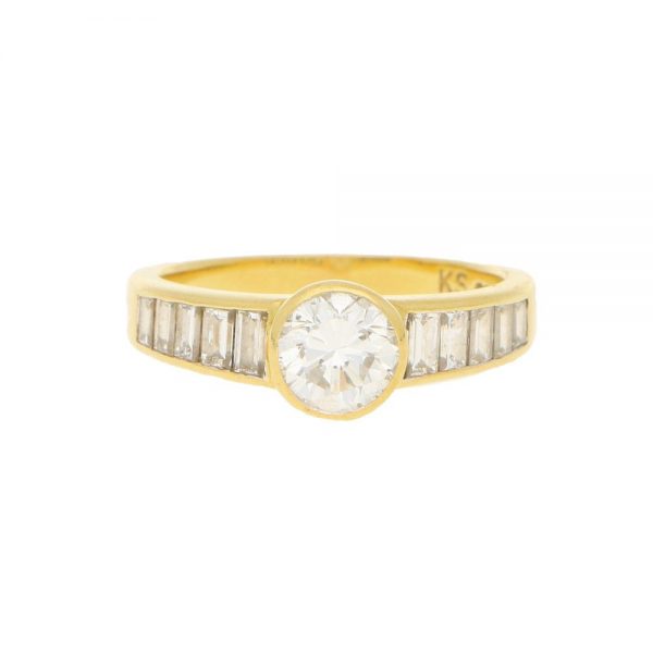 Contemporary 1ct Diamond Ring with Baguette Shoulders; central collet-set 1ct round brilliant-cut diamond flanked to each side by 1ct graduated baguette-cut diamonds in 18ct yellow gold